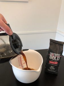 Pour Detroit bold coffee into container